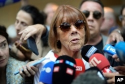 Gisele Pelicot speaks to media as she leaves the Avignon courthouse in southern France, Sept. 5, 2024. Pelicot, who was allegedly drugged by her ex-husband so she could be raped by other men while she laid unconscious, is expected to testify.