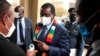 FILE PHOTO: Zimbabwe's President Mnangagwa has his temperature taken as he arrives at the parliament in Harare