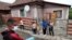 FILE – A Roma activist carries food donations during the COVID-19 outbreak in Miskolc, Hungary, April 30, 2020. Roma leaders are urging the government to do more to intervene and tackle what has been described as a humanitarian crisis.