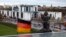 FILE - A German national flag flutters in front of the Chancellery in Berlin.