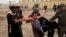 Protesters carry an injured man during clashes in Fallujah, 40 miles (65 kilometers) west of Baghdad, Iraq, January 25, 2013. 