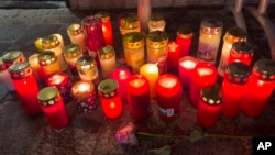 Candles mark the site of a stabbing attack in Villach, Austria, Feb. 16, 2025.