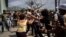 FILE - In this July 11, 2021 file photo, police scuffle and detain an anti-government demonstrator during a protest in Havana, Cuba.