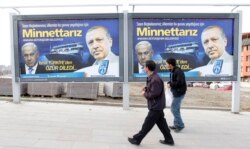 FILE - Pedestrians look at billboards with the pictures of Turkey's Prime Minister Tayyip Erdogan, right, and his Israeli counterpart Benjamin Netanyahu, in Ankara.