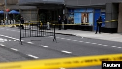 Police officers stand near the scene where United Healthcare CEO Brian Thompson was shot and killed in Midtown Manhattan in New York on Dec. 4, 2024.