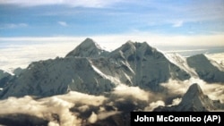 FILE - The southern face of Mount Everest, known locally as Sagarmatha, soars above the monsoon clouds Saturday, August 26, 2000 at the border of Nepal and Tibet.