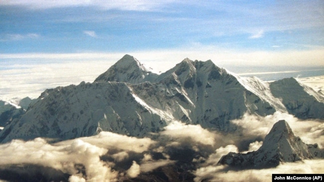 FILE - The southern face of Mount Everest, known locally as Sagarmatha, soars above the monsoon clouds Saturday, August 26, 2000 at the border of Nepal and Tibet.