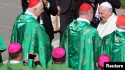 FILE - Chinese bishop Joseph Guo Jincai (L) takes a picture of Pope Francis after a mass for the opening of a synodal meeting in Saint Peter's square, at the Vatican.