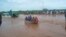 Passengers of a bus that was swept away by floodwaters are rescued by boat, near Garissa, Kenya, on April 9, 2024.