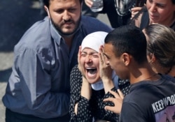 The wife of Rami Kaaki, one of ten firefighters who were killed during the last week's explosion that hit the seaport of Beirut, Lebanon, mourns during her husband's funeral at the firefighter headquarters, August 11, 2020.