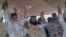  Malik Ishaq, center, a leader of the banned Sunni Muslim group Lashkar-e-Jhangvi, and his colleagues raise hands to response their supporters July 15, 2011