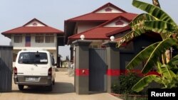 FILE - A van enters a residence that temporarily housed asylum seekers coming from a remote South Pacific detention center, in Phnom Penh, Cambodia. Gen. Tan Sovichea, head of the refugee office in Cambodia's Interior Ministry, said the Iranian couple departed for Iran on February 12.