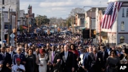 FILE —Vice President Kamala Harris and many others walk across the Edmund Pettus Bridge commemorating the 59th anniversary of the Bloody Sunday voting rights march in 1965, Sunday, March 3, 2024, in Selma, Ala.