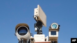 FILE - Cameras of a Border Patrol surveillance system are seen on a plateau near the U.S.-Mexico border, in Sunland Park, New Mexico, June 6, 2019. 
