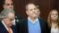 FILE - Film producer Harvey Weinstein stands with his lawyer, Benjamin Brafman, left, inside Manhattan Criminal Court during his arraignment in Manhattan, New York, May 25, 2018.