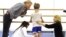FILE - Artistic director of the School of American Ballet (SAB), Peter Martins (L) and SAB teachers look over an eight-year-old student during the school's 2009 Spring Auditions at Lincoln Center, in New York, May 5, 2009.
