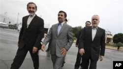 Iranian President Mahmoud Ahmadinejad, center, makes his way during a departure ceremony for him as he leaves the country for Turkey to attend an international conference in Tehran, Iran, May 9, 2011.