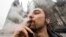 A man smokes cannabis in Cologne, Germany, on April 1, 2024. European police on April 11 arrested members of a gang they say defrauded victims in 35 countries in a medical cannabis Ponzi scheme.