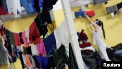 Clothes hang on a line to dry at a shelter for people affected by the floods caused by heavy rain brought by Storm Iota, in San Pedro Sula, Honduras, Nov. 19, 2020.