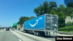FILE - An Amazon Prime truck travels on an Interstate highway in Fairfax, Virginia, July 14, 2019.