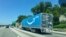 FILE - An Amazon Prime truck travels on an Interstate highway in Fairfax, Virginia, July 14, 2019.