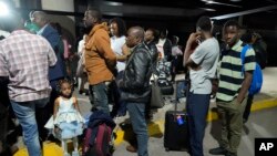 \FILE: Zimbabwean evacuees from Sudan arrive at the Robert Mugabe International airport in Harare, Zimbabwe, Friday, April, 28, 2023. Zimbabwe received its first batch of 42 evacuees from Sudan, Friday according to the countries authorities.
