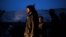 Syrian people seen near a damaged building after it was attacked by a Syrian Army Jet in Azaz, Syria, Sunday, Dec 16, 2012.