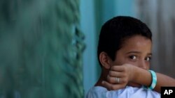 Edwin Lemus, 10, from El Salvador, sits in the men's section of a shelter providing temporary refuge to Central American migrants on their way north, in Arriaga, Chiapas State, Mexico, June 18, 2014.