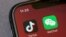 Icons for the smartphone apps TikTok and WeChat are seen on a smartphone screen in Beijing, Aug. 7, 2020. 