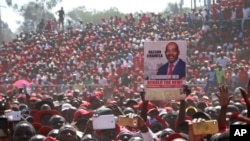 Movement for Democratic Change (MDC) supporters hold a poster of leader Nelson Chamisa during the party's 19th-anniversary celebrations in Harare, Zimbabwe, Saturday, Oct. 27, 2018.