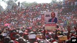 FILE: Movement for Democratic Change (MDC) supporters hold a poster of leader Nelson Chamisa during the party's 19th-anniversary celebrations in Harare, Zimbabwe, Saturday, Oct. 27, 2018.