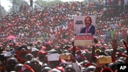 Movement for Democratic Change (MDC) supporters hold a poster of leader Nelson Chamisa during the party's 19th-anniversary celebrations in Harare, Zimbabwe, Saturday, Oct. 27, 2018.