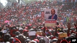 FILE: Movement for Democratic Change (MDC) supporters hold a poster of leader Nelson Chamisa during the party's 19th-anniversary celebrations in Harare, Zimbabwe, Saturday, Oct. 27, 2018.