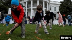 FILE - Children participate in the annual White House Easter Egg Roll on the South Lawn of the White House in Washington, April 2, 2018. The event has been on hiatus the past two years due to the COVID-19 pandemic.