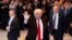  President-elect Donald Trump waves to the crowd as he leaves The New York Times building following a meeting, Nov. 22, 2016, in New York.