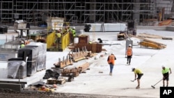 Workers go about their duties at a construction site in Sydney, Wednesday, Sept. 2, 2020. 