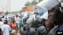 FILE - Police stand guard following demonstrations in Kinshasa, Democratic Republic of Congo, Jan. 12, 2015. 