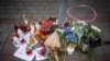 FILE - Candles and flowers have been placed on the pavement outside a gay bar where two men were shot dead the night before, in Bratislava, Slovakia, on Oct. 13, 2022. The attack was linked to the Terrorgram group, an extreme right-wing online network.