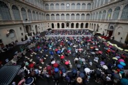 People attend Pope Francis' weekly general audience at the San Damaso courtyard, at the Vatican, Sept. 23, 2020.