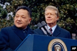 FILE - In this Jan. 29, 1979 file photo, then U.S. President Jimmy Carter, right, and then Chinese Vice Premier Deng Xiaoping are seen outside the White House in Washington.