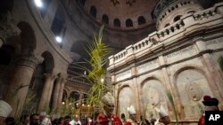 FILE—Pierbattista Pizzaballa, the Latin Patriarch of Jerusalem, walks in a procession during the Palm Sunday Mass in the Church of the Holy Sepulchre, where many Christians believe Jesus was crucified, buried and rose from the dead, in the Old City of Jerusalem, April 2, 2023