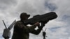 A Ukrainian serviceman tests an anti-drone gun during a presentation of radio-electronic warfare and radio-electronic intelligence systems of the Ukrainian company Kvertus in Lviv region on May 28, 2024, 