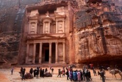 FILE - Tourists visit the Treasury, Jordan's most famous archaeological monument leftover from the Nabatean civilization, in the kingdom's Petra archaeological park, Feb. 13, 2017.