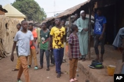 FILE— People gather around an area were gunmen kidnapped school children in Chikun, Nigeria, March 7, 2024.