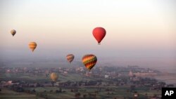 Hot air balloons fly over the west bank of the Nile River in Luxor, Egypt, April 1, 2016.