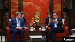 Chinese Premier Li Keqiang talks with Executive Vice President and Head of International Affairs at the U.S. Chamber of Commerce Myron Brilliant, during a meeting with a group of U.S. entrepreneurs at Zhongnanhai in Beijing, China, Sept. 10, 2019.