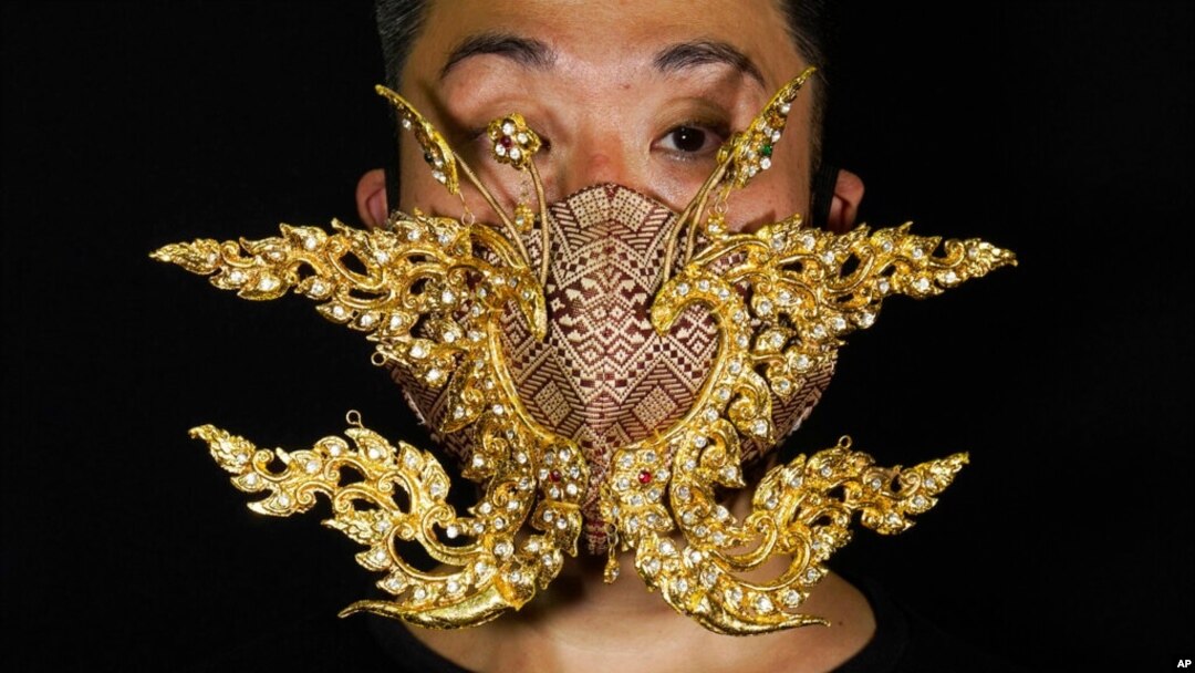 Edmond Kok, a Hong Kong theater costume designer and actor, wearing a face mask inspired by the decoration of Thai temple to Kok's face in Hong Kong Thursday, Aug. 6, 2020. With little theater work…