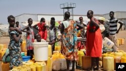 FILE - Residents of the Mangateen Camp for the internally displaced line up for water from a borehole, on the outskirts of the capital Juba, South Sudan, Jan. 22, 2019. 