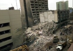 FILE - The United States Embassy, left, is pictured with blasted ruins next to it in downtown Nairobi, Kenya, Aug. 8, 1998, the day after terrorist bombings in Kenya and Dar es Salaam, Tanzania.