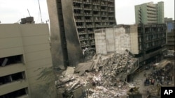FILE - The United States Embassy, left, is pictured with blasted ruins next to it in downtown Nairobi, Kenya, Aug. 8, 1998, the day after terrorist bombings in Kenya and Dar es Salaam, Tanzania.
